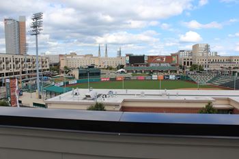 A baseball field is in the foreground of a cityscape.